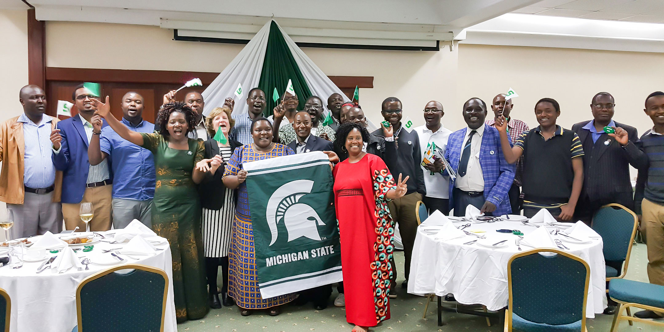 This is a photo of Kenyan alumni and friends at a Michigan State University gathering. This photo was taken prior to the global pandemic.